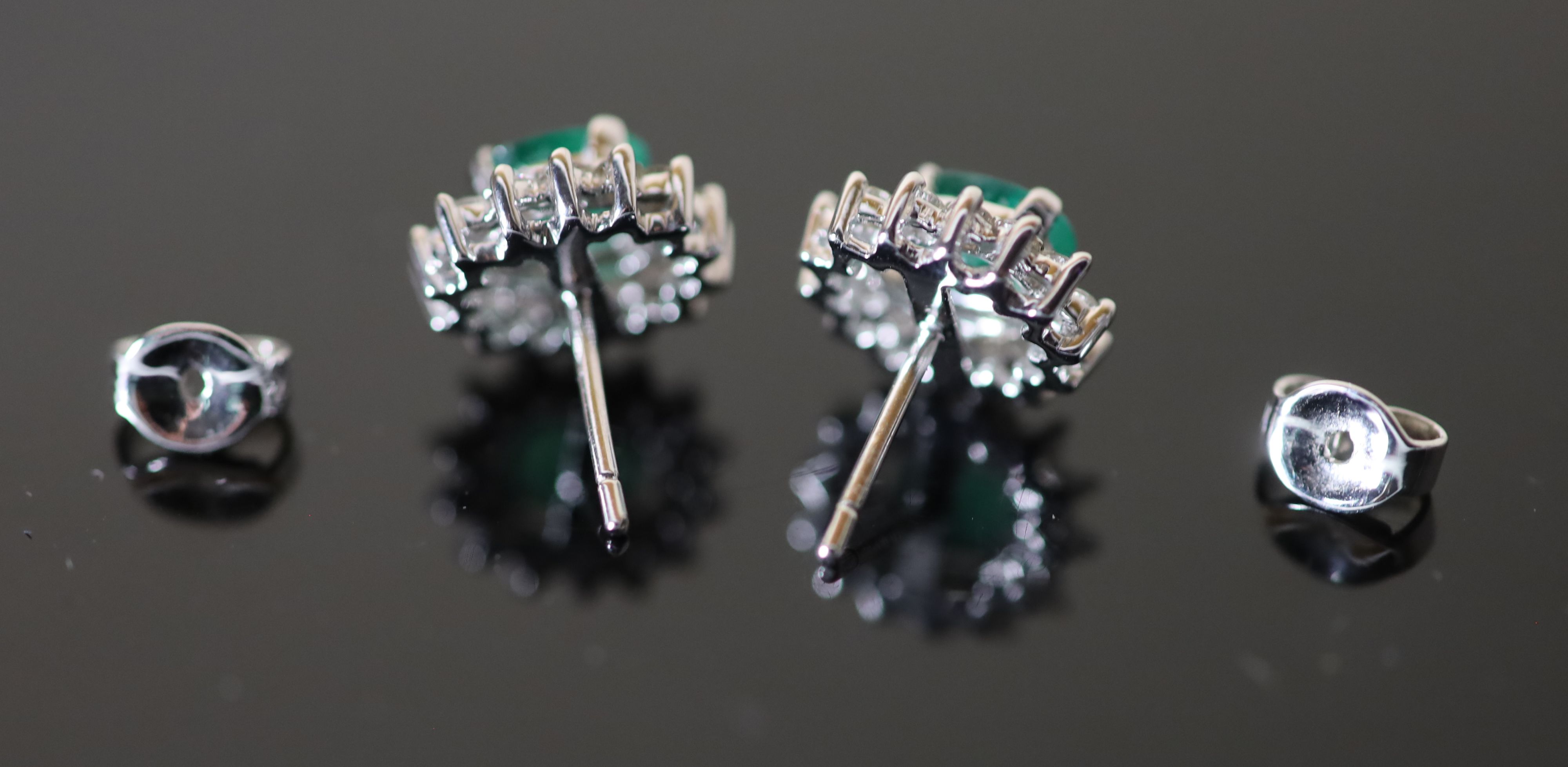 A modern pair of white gold?, emerald and diamond cluster oval earrings,